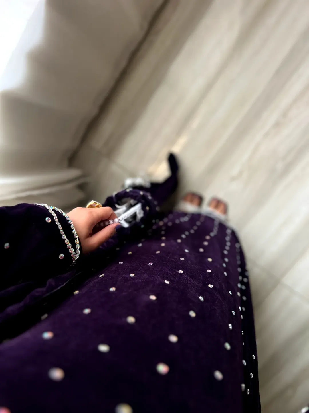 Scattered crystal stones across the plum 12000 velvet fabric of the Velvet Gazal three-piece suit