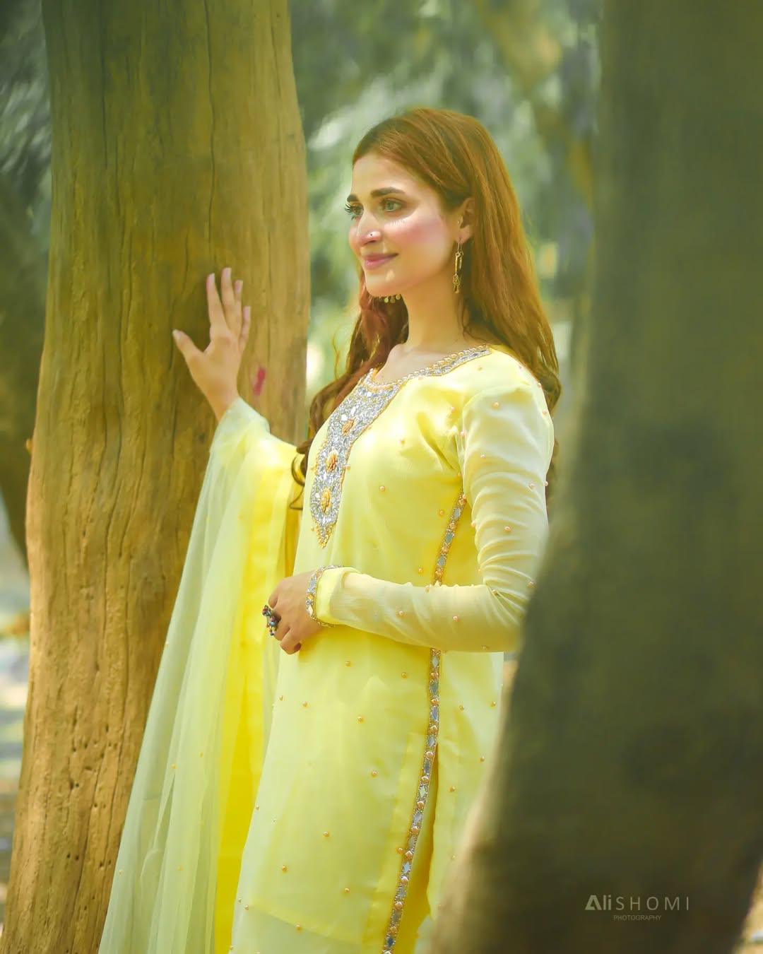 Zari Lemon chiffon sharara set in outdoor side pose with long shirt and softly draped net dupatta by Anabiyawear